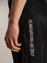 Black A-Dura Elite Flex Shorts featuring ripstop fabric, a vertical zippered pocket, and grey Alpinestars logo.