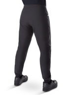 Alpinestars A-Dura Waterproof Pants, Mountain Bike Pants, Black, rear view worn with black shoes, featuring a durable 3-layer membrane, regular fit, and elasticated cuffs for off-road cycling