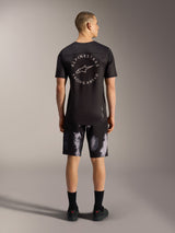 A-Dura Ride Shorts in Black Camo, durable 4-way stretch MTB shorts for men, shown from the back in a studio setting.