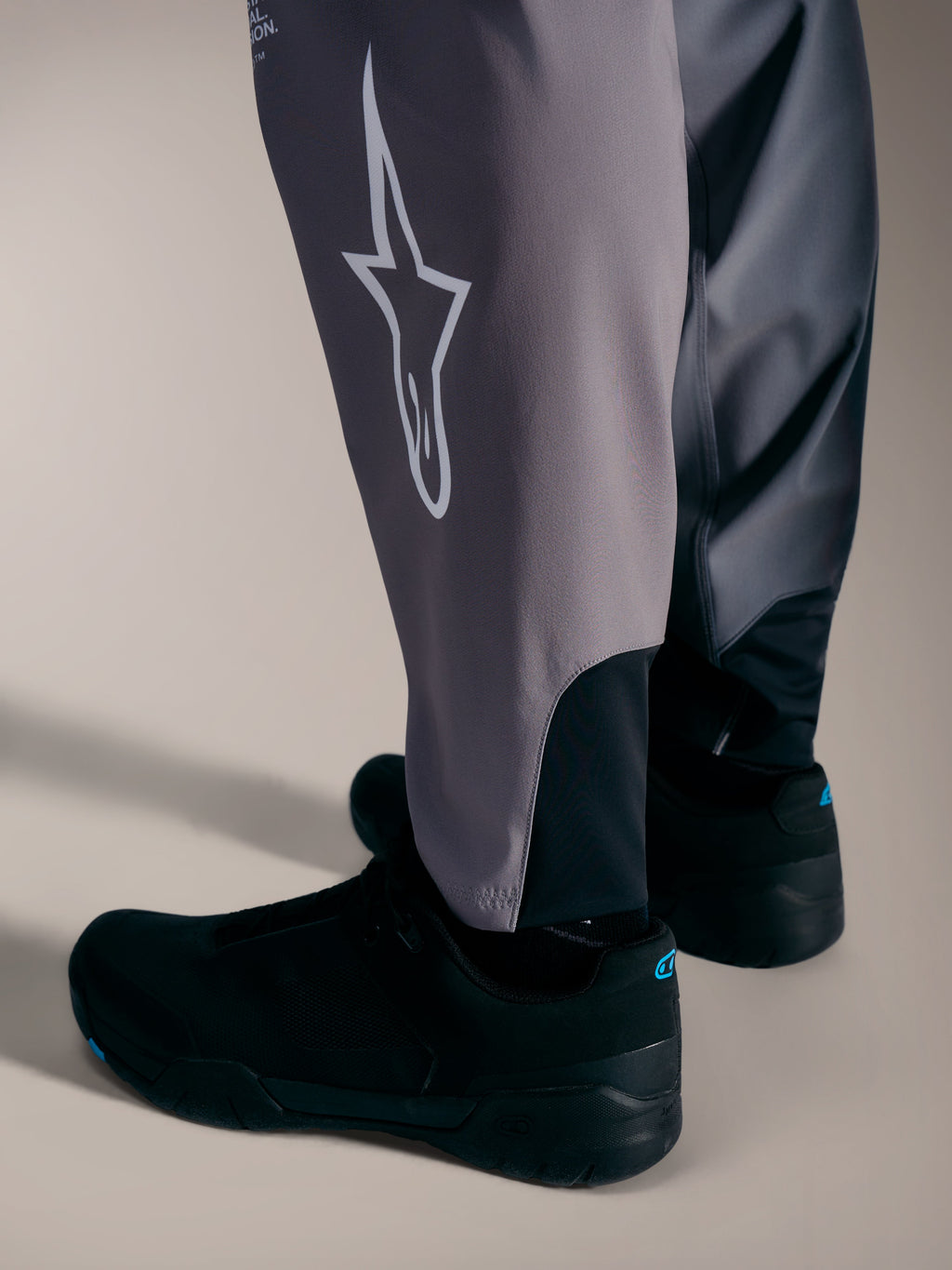 Alpinestars A-Supra Elite Calças cinzentas, com logótipo Astars branco e punhos elásticos para competição de BTT.