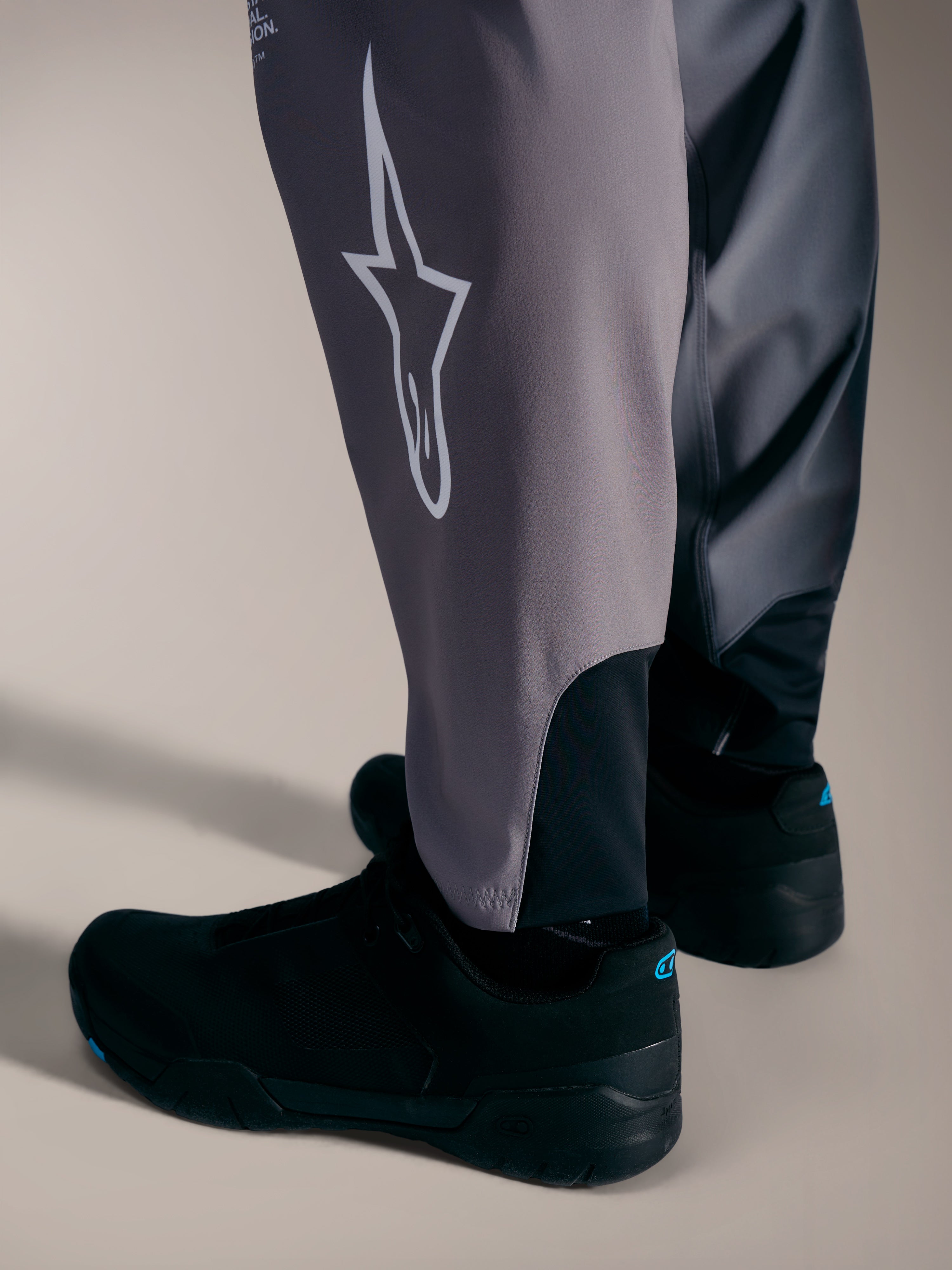 Alpinestars A-Supra Elite Calças cinzentas, com logótipo Astars branco e punhos elásticos para competição de BTT.