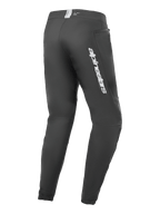 Calças Alpinestars A-Dura Elite, calças de mountain bike, pretas, vista lateral traseira com marca Alpinestars prateada na coxa, bolso com fecho e punhos elásticos, equipamento técnico durável para MTB