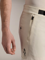 Alpinestars A-Aria Elite Shorts, Mountain Bike Shorts, Ecru, close-up side view showing zippered pocket and magnetic buckle closure, performance cycling apparel with black accents