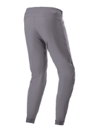 Calças Alpinestars A-Dura, calças de ciclismo BTT, cinzento escuro, vista traseira de três quartos, mostrando o tecido durável com elasticidade em 2 direções, punhos elásticos e ajuste ergonómico concebido para performance em trilhos de BTT.