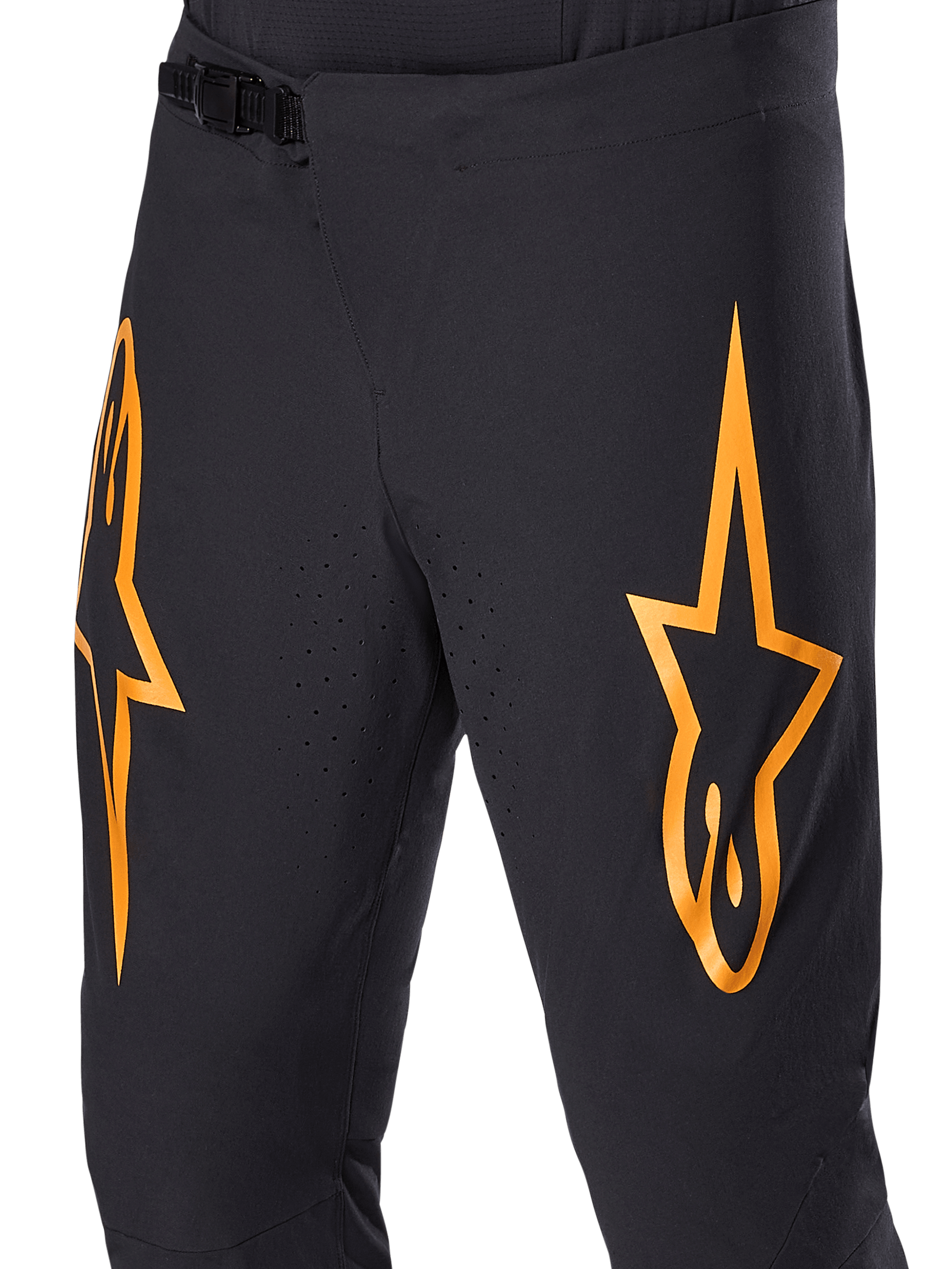 Alpinestars A-Supra Race Pants, Black MTB Cycling Pants with large orange star logos, featuring a front ratchet closure and laser-perforated ventilation holes, performance-oriented technical design.