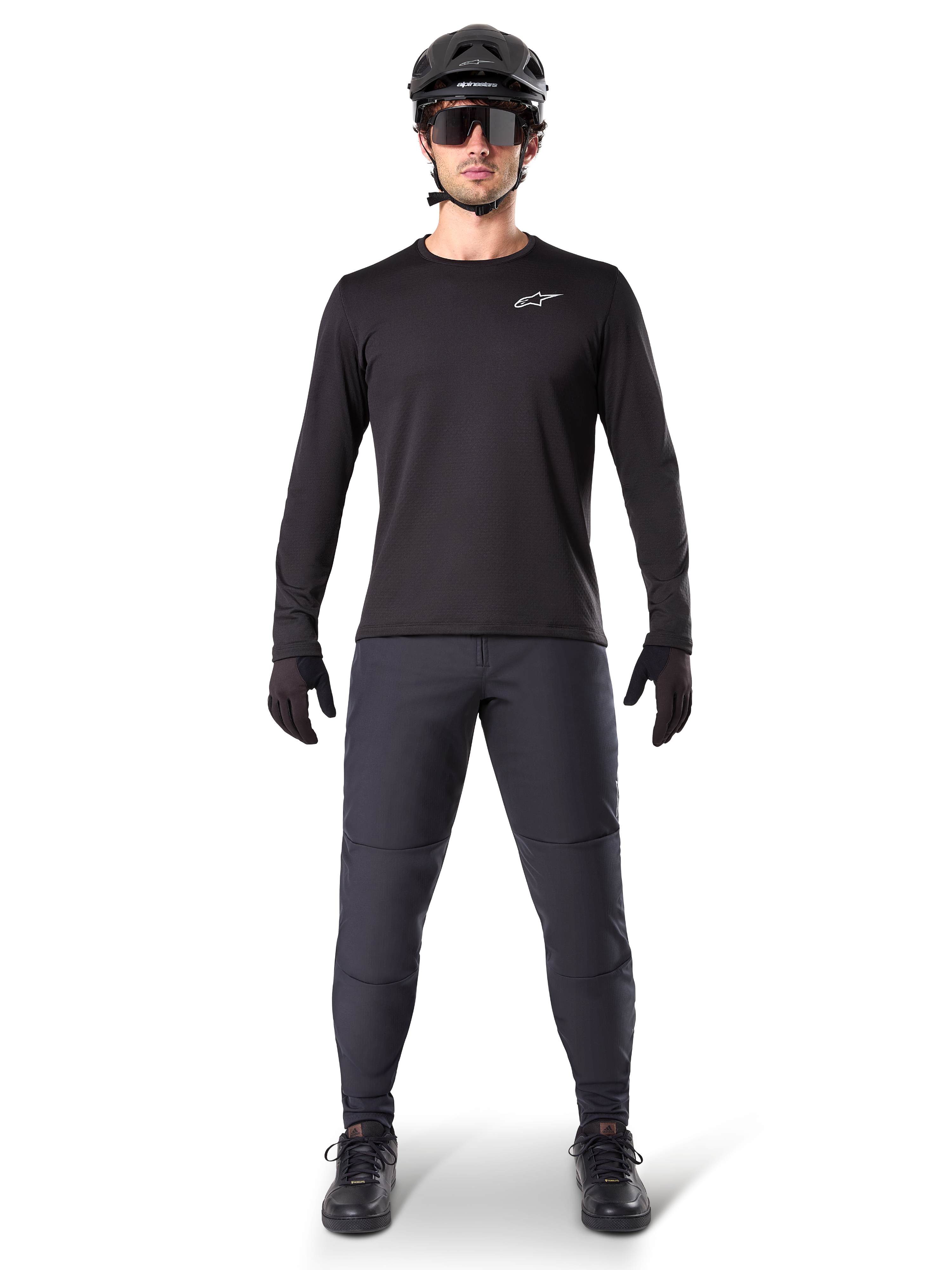 Alpinestars A-Dura Thermal Jersey, Black long-sleeve mountain bike jersey, worn with dark grey pants, black gloves, black helmet and sunglasses, featuring a white Alpinestars logo on the chest, coordinated outfit for cold-weather mountain biking