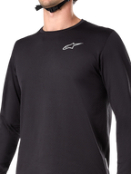 Alpinestars A-Dura Thermal Jersey, Long Sleeve Cycling Jersey, Black, featuring white wordmark logo on chest, insulated fleece-lined fabric, extended drop tail, designed for cold weather mountain biking