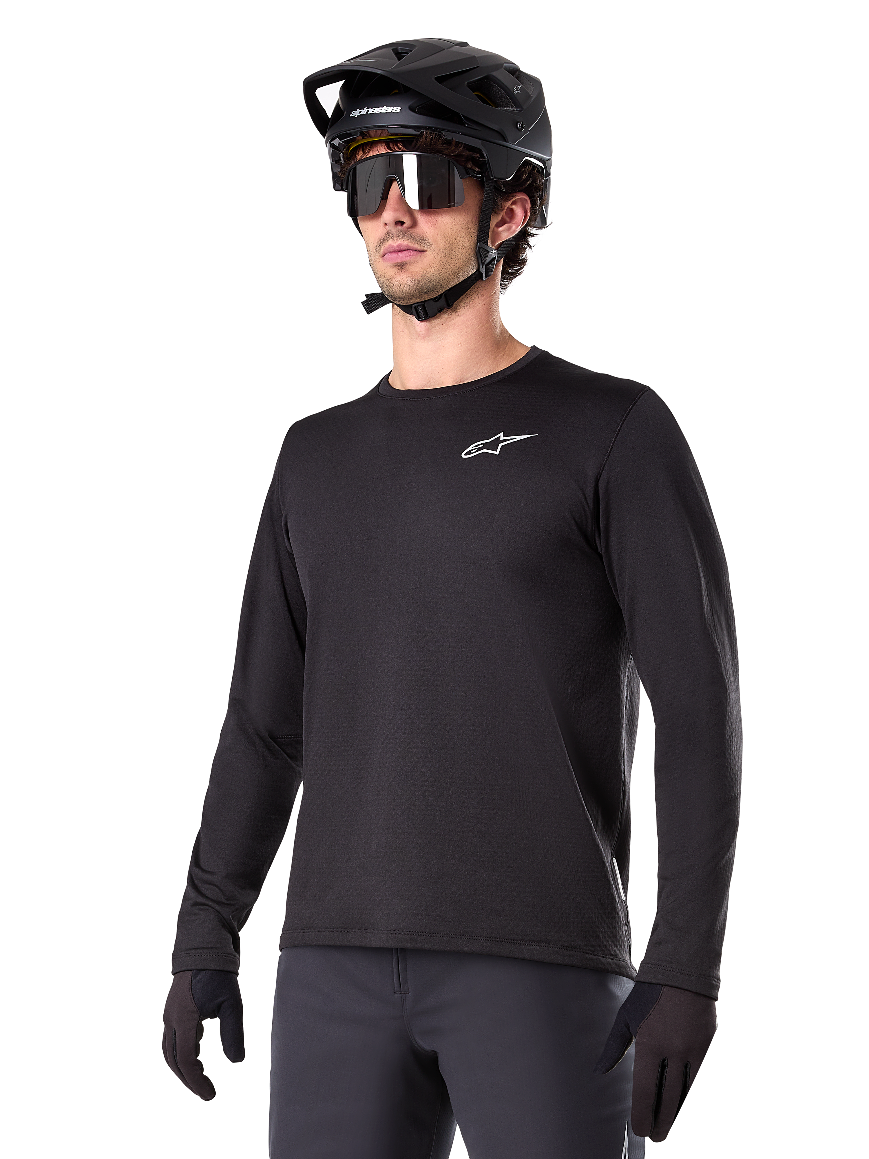 Alpinestars A-Dura Thermal Jersey, Black long-sleeve mountain bike jersey, white chest logo, worn with black helmet and gloves, sleek sporty design for trail riding