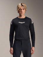 Alpinestars A-Aria Polartec Elite Jersey, Long Sleeve MTB Jersey, Black, featuring white 'astars' chest logo and white shoulder graphics, performance cycling gear worn by a model