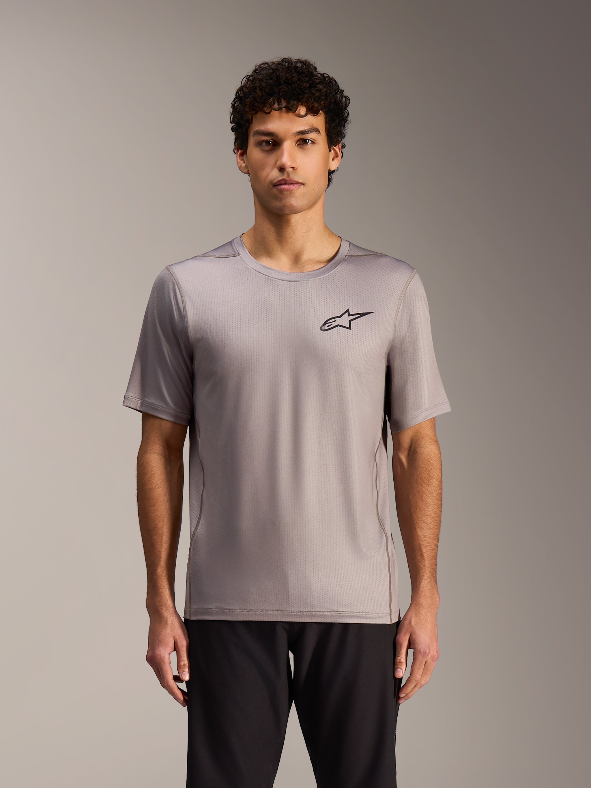 Camisola Alpinestars A-Dura Air cinzenta, mangas curtas com logótipo preto e construção em malha jacquard respirável.