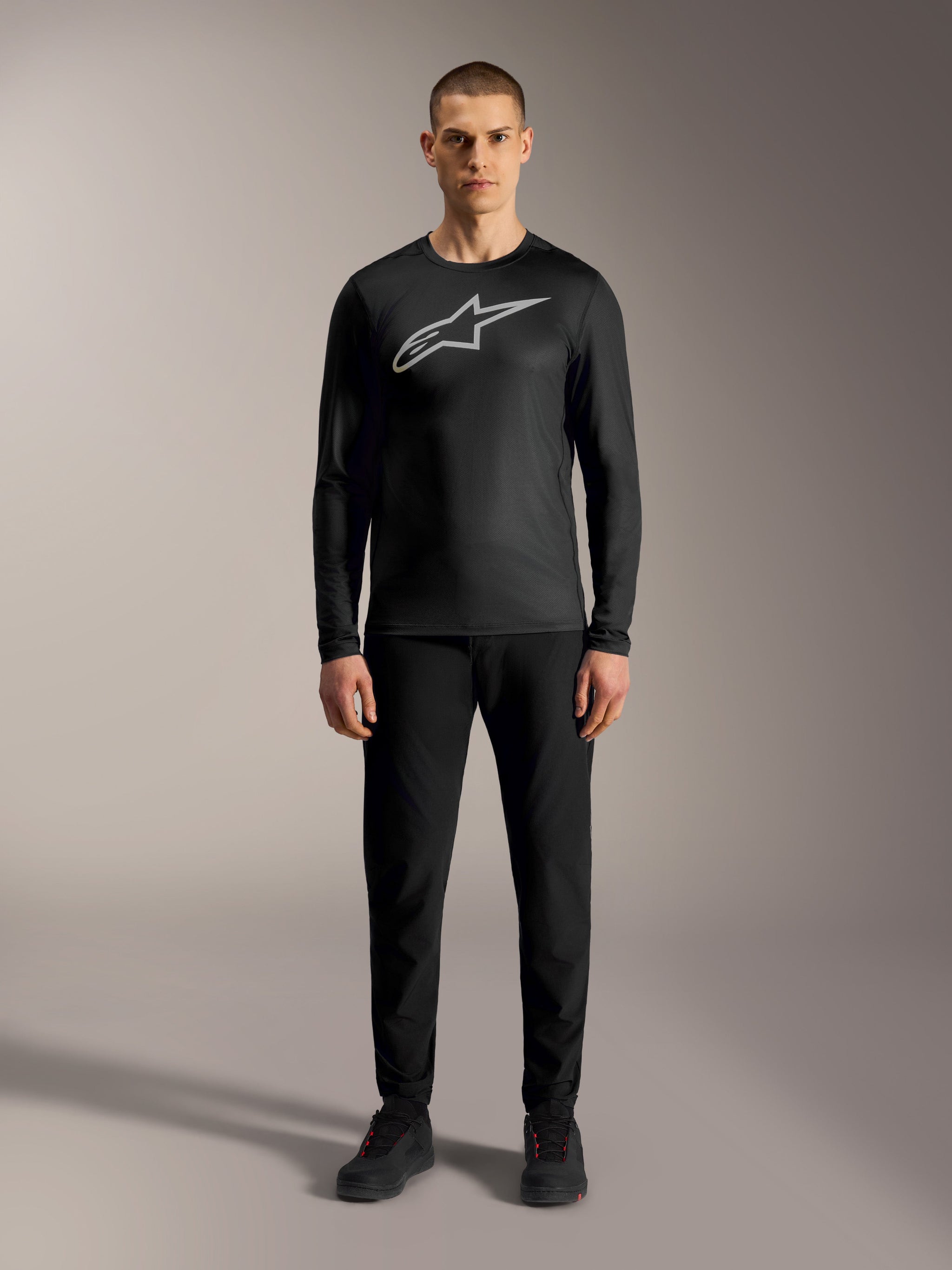 A-Dura Ride Long Sleeve Jersey in black with silver logo, paired with matching black MTB pants for high-performance riding.