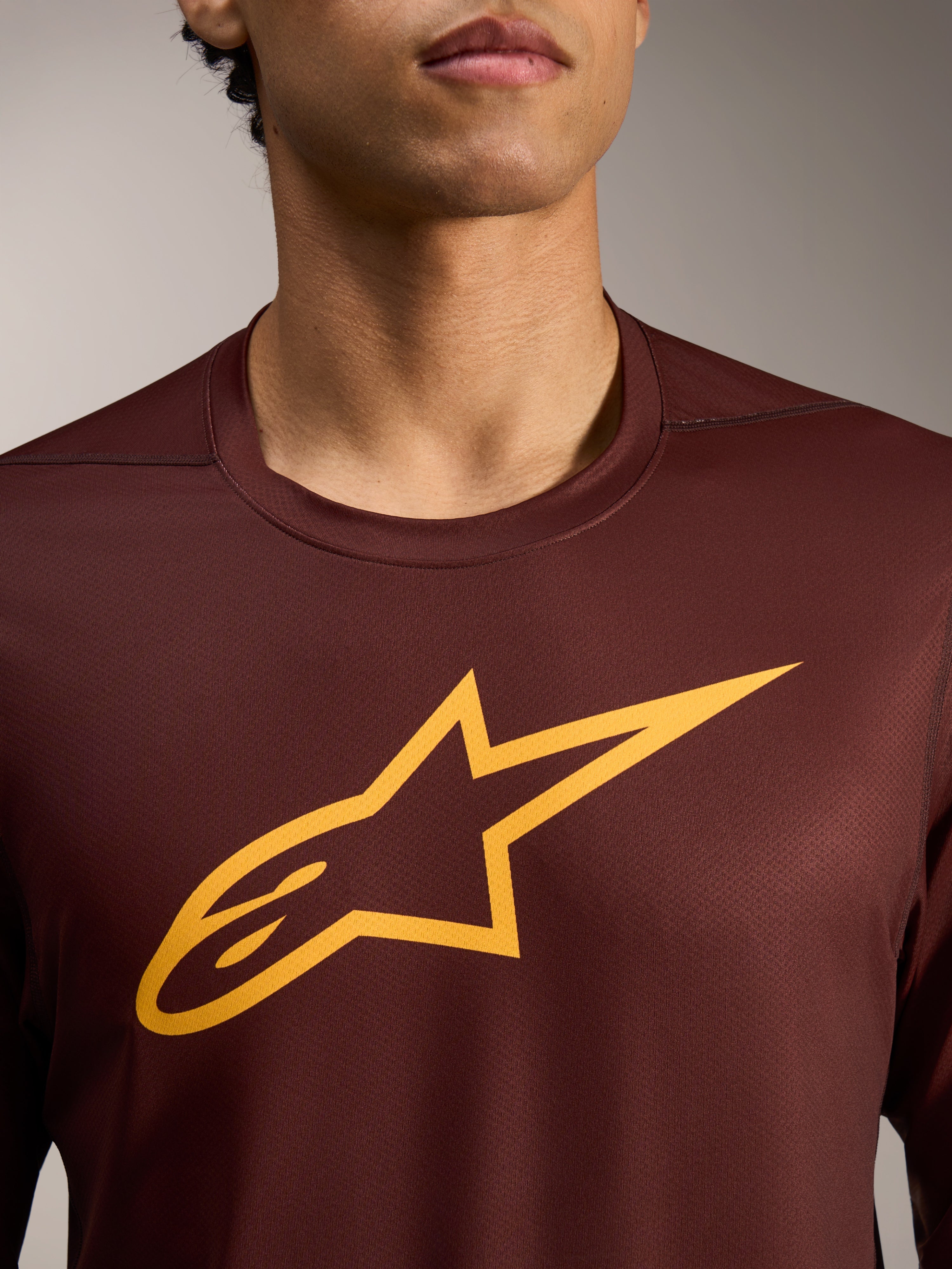 Camisola A-Dura Ride bordeaux de manga comprida com logótipo Astars amarelo em tecido jacquard de performance.