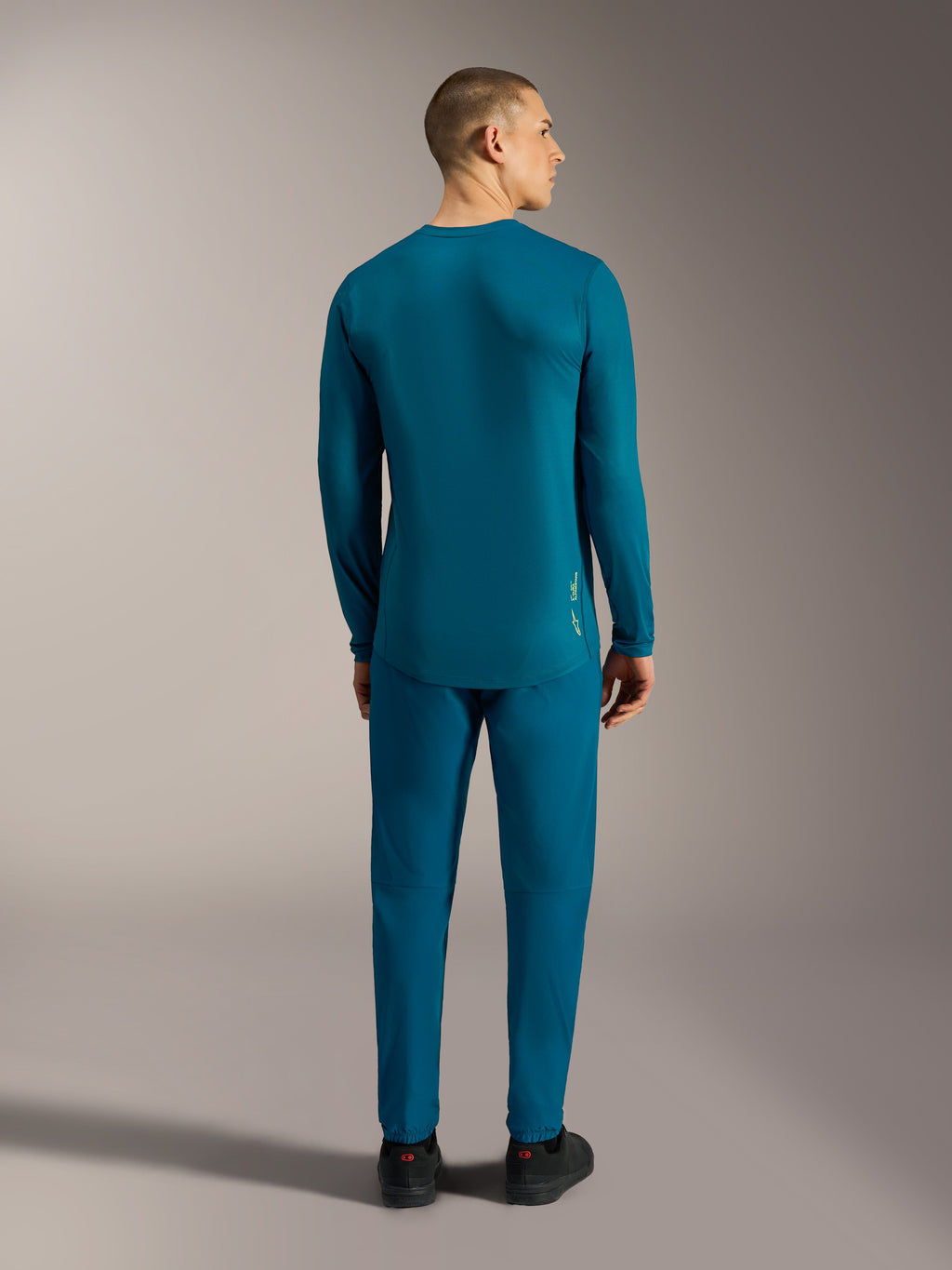 Camisola de mangas compridas A-Dura Ride azul esverdeado, vista traseira com cauda longa para performance em BTT.