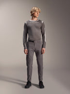 Alpinestars A-Dura Elite Pants, Dark Gray mountain bike pants, full-body view, worn with a coordinating gray long-sleeve performance jersey featuring the Alpinestars logo, black shoes with red accents, athletic cycling outfit