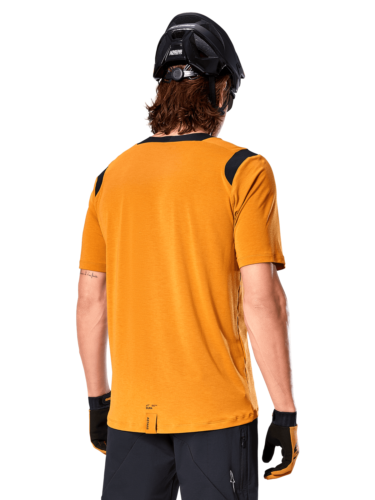 Camisola Alpinestars A-Dura Dri Wool de Manga Curta, Amarelo Escuro, vista traseira de um homem a usar a camisola com painéis de malha pretos nos ombros, combinada com capacete de BTT e luvas pretas, equipamento de ciclismo de montanha de ajuste regular