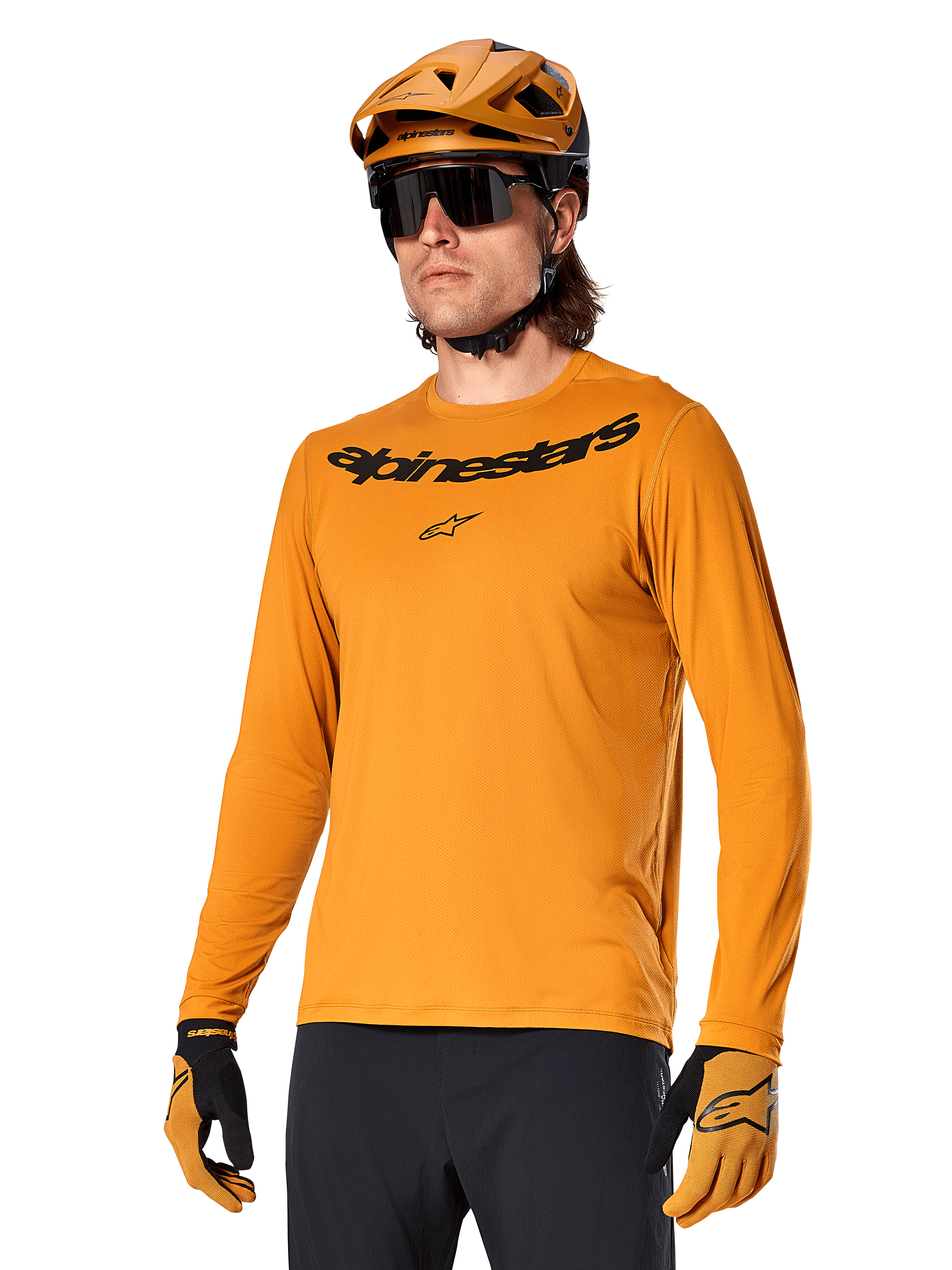 Alpinestars A-Dura Rocker Long Sleeve Jersey, MTB Mountain Biking Jersey, Dark Gold, person wearing jersey with matching helmet and gloves, sporty coordinated look with Alpinestars wordmark on chest