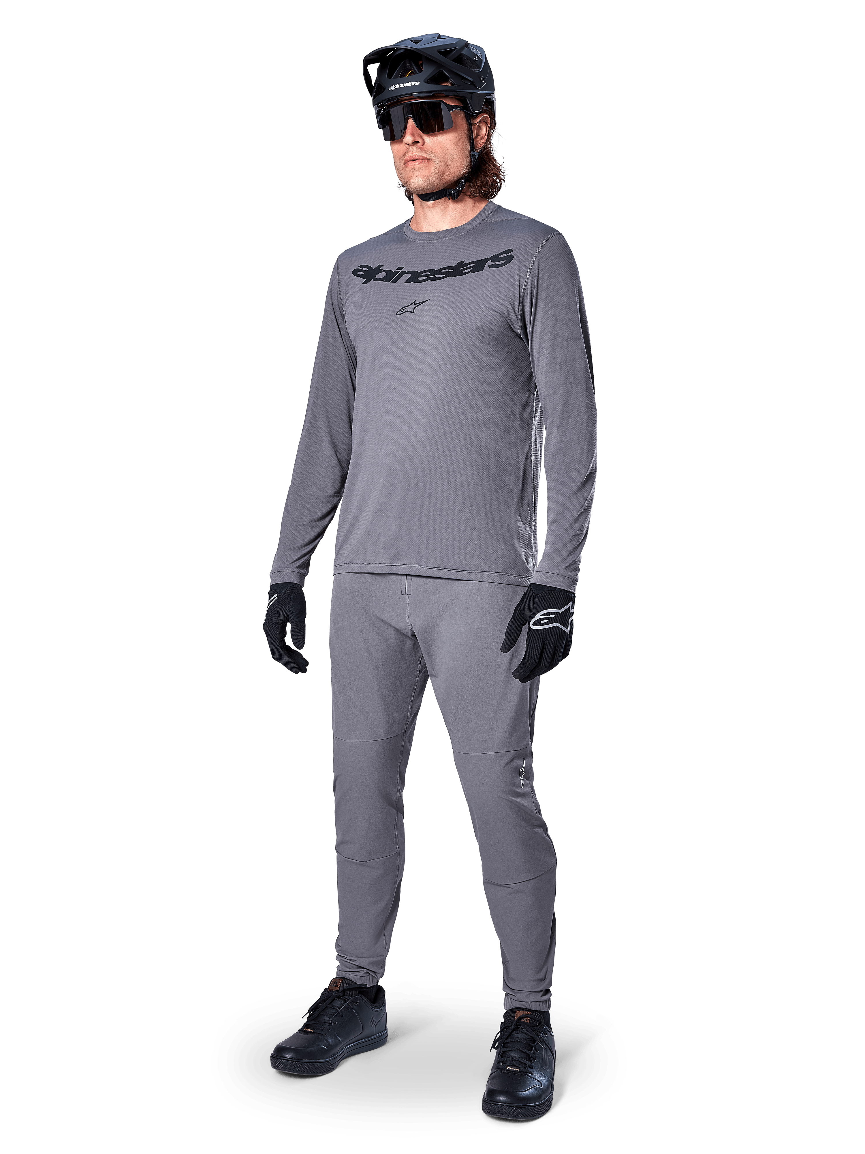 Alpinestars A-Dura Rocker Jersey - Long Sleeve, Dark Gray, worn by a model with matching gray pants, black mountain bike helmet, sunglasses, and gloves, casual MTB style for off-road riding