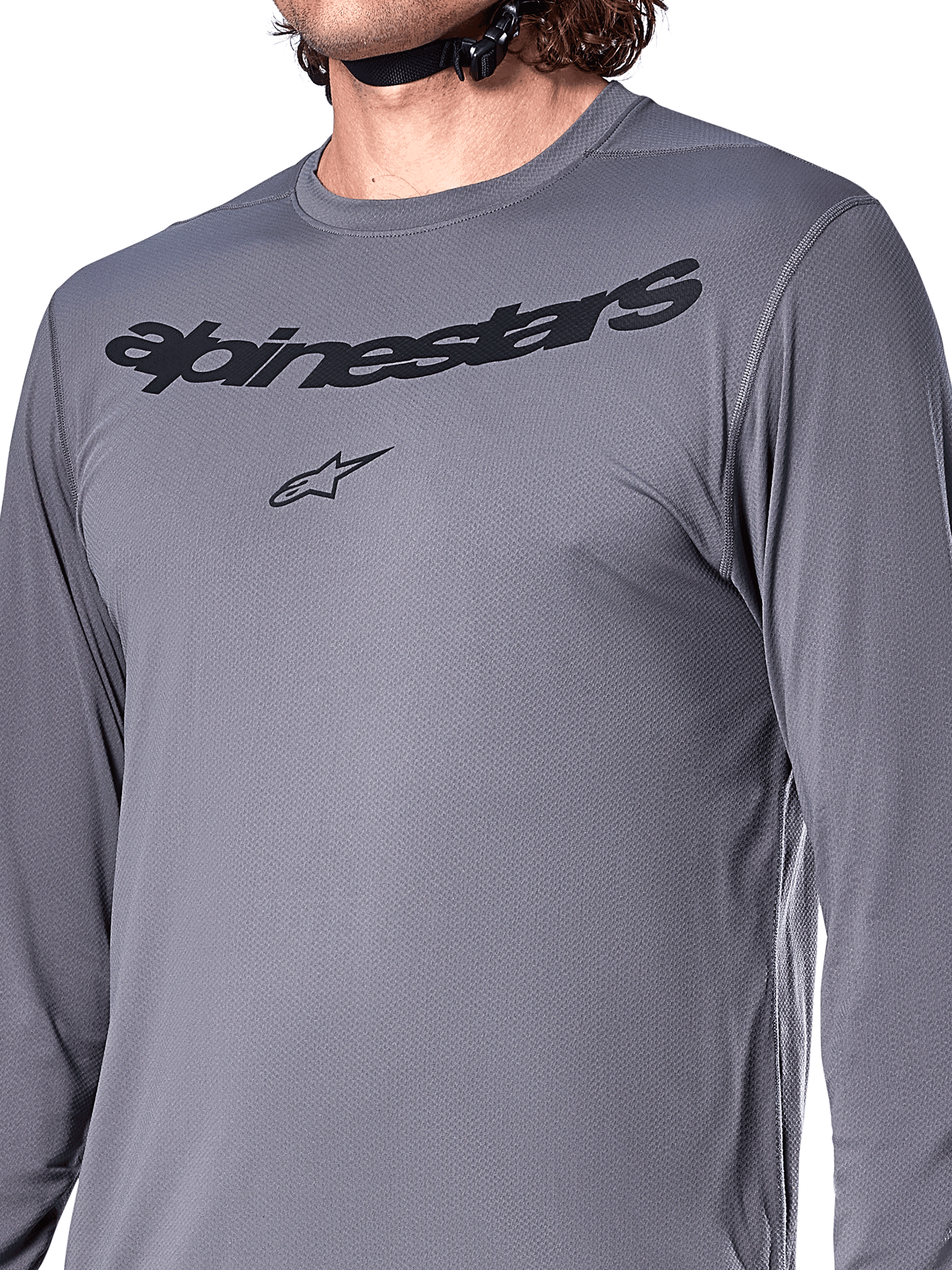 Alpinestars A-Dura Rocker Long Sleeve Jersey, Dark Gray, close-up of chest featuring black Alpinestars wordmark and star logo, jacquard poly-spandex material, performance mountain bike apparel