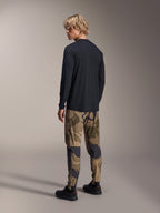 Alpinestars A-Dura Astar Long Sleeve Jersey, Black, back view on a model, paired with camouflage pants, casual MTB performance gear with a drop tail hem and regular fit