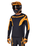 Alpinestars A-Supra Race Jersey - Manga Comprida, camisola de ciclismo MTB, preto e laranja, usada com capacete e luvas a condizer, com a marca Alpinestars no peito e detalhes estilizados nas mangas, ajuste de performance para corridas fora de estrada