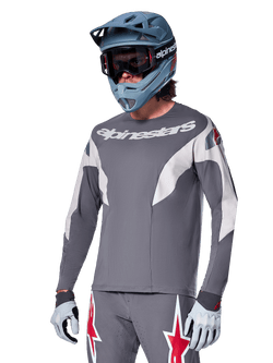 Alpinestars A-Supra Race Jersey - Long Sleeve, Dark Gray with white and red accents, racing-style graphics, worn with matching gray pants, blue full-face helmet, and white gloves, professional MTB and downhill racing gear