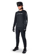 Alpinestars A-Dura Switch Long Sleeve Jersey, Black, mountain bike jersey worn with black pants, helmet, and gloves, featuring white wordmark logo on chest and star logos on sleeves, coordinated MTB gear for off-road riding