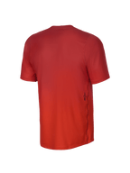 Alpinestars Camisola de Manga Curta Youth A-Dura Rise, vista traseira, Spicy Orange, com textura de tecido jacquard, um pequeno logótipo Astars preto na parte lateral inferior e uma bainha traseira mais comprida para cobertura em BTT.
