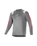 Alpinestars Youth A Supra Astar Jersey, camisola de manga comprida para jovens, cinzenta escura com detalhes brancos nos ombros e marca vermelha nas mangas, logótipo branco no peito, tecido técnico respirável, gola redonda, corte atlético de alta performance para mountain biking