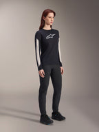 Alpinestars Women Stella A-Dura Dri Astar Long Sleeve Jersey, Black, featuring white mesh sleeve panels and white Astar logo, worn with black pants and shoes, technical cycling activewear for mountain biking