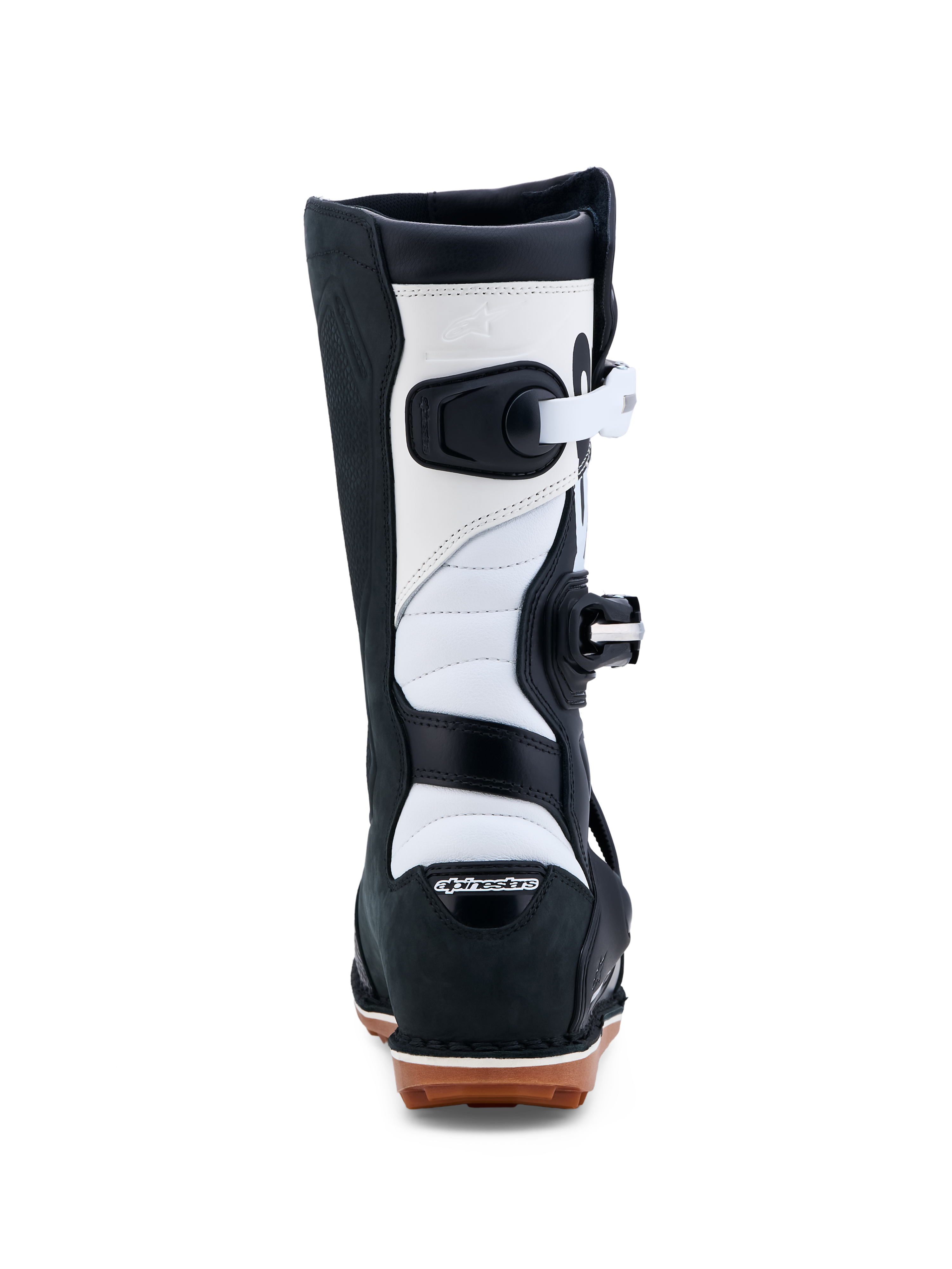 Alpinestars Tech-T, botas de moto para trial, pretas e brancas, certificadas CE, construção em couro com sola de borracha aderente, vista traseira.