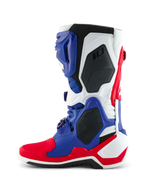 Alpinestars Limited Edition Fortitude Tech 10 Boot, Motocross Boot, Bright Red White and Blue, lateral profile view featuring a multi-paneled TPU chassis, black protective honeycomb inserts, and Alpinestars branding, professional-grade off-road racing footwear