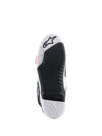 Sola das botas Alpinestars Tech 10 Supervented, vista inferior, design de composto duplo em preto e branco, textura de aderência em favo de mel, inserção central substituível, logótipo Alpinestars em relevo, otimizada para o desempenho nos apoios de pés de motocross