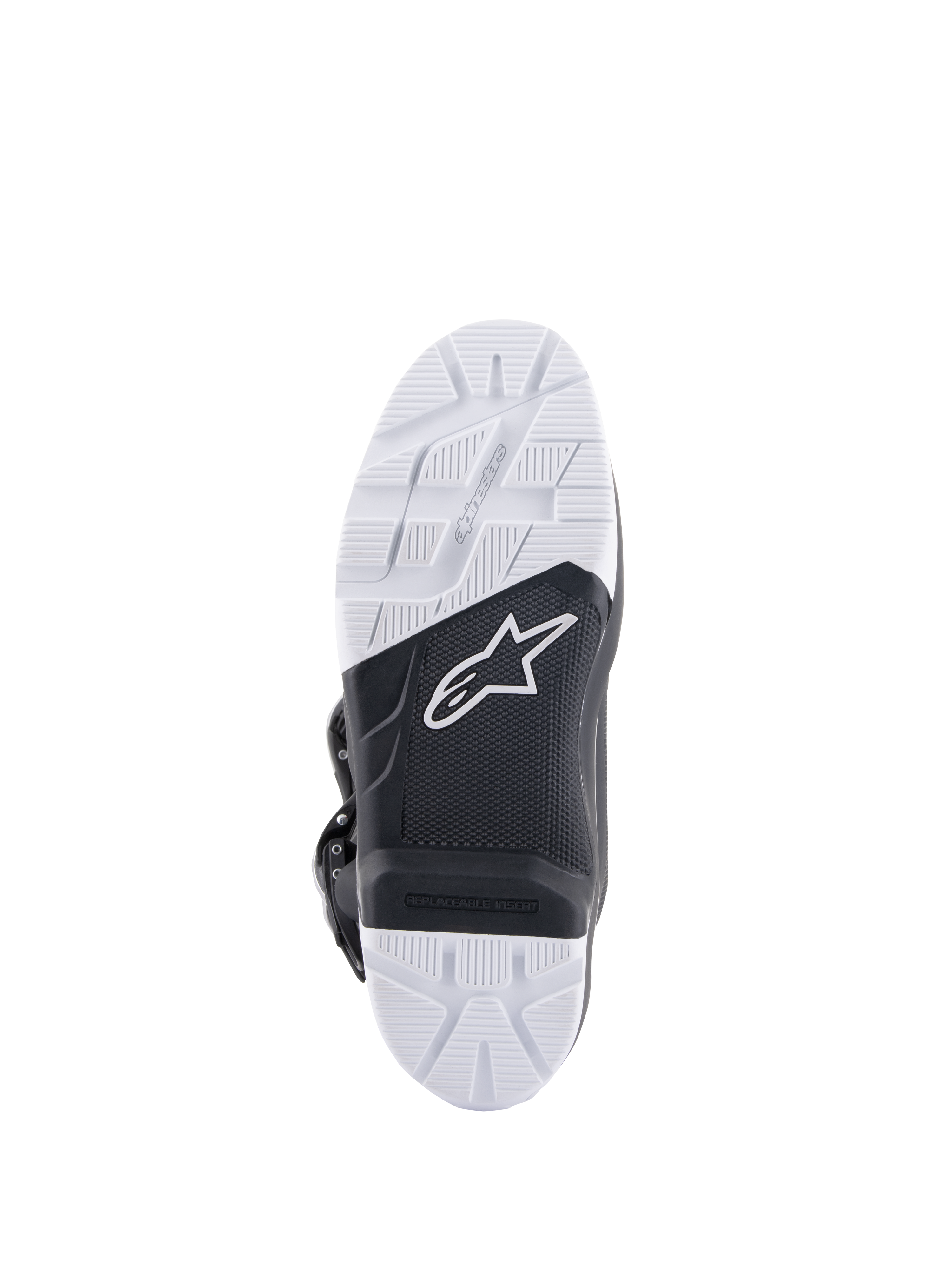 Botas Alpinestars Tech 7 Enduro, vista da sola mostrando a sola de composto especificamente projetada, design bicolor em preto e branco com padrões de aderência texturizados, logótipo da estrela branca e um inserto de apoio para os pés substituível.