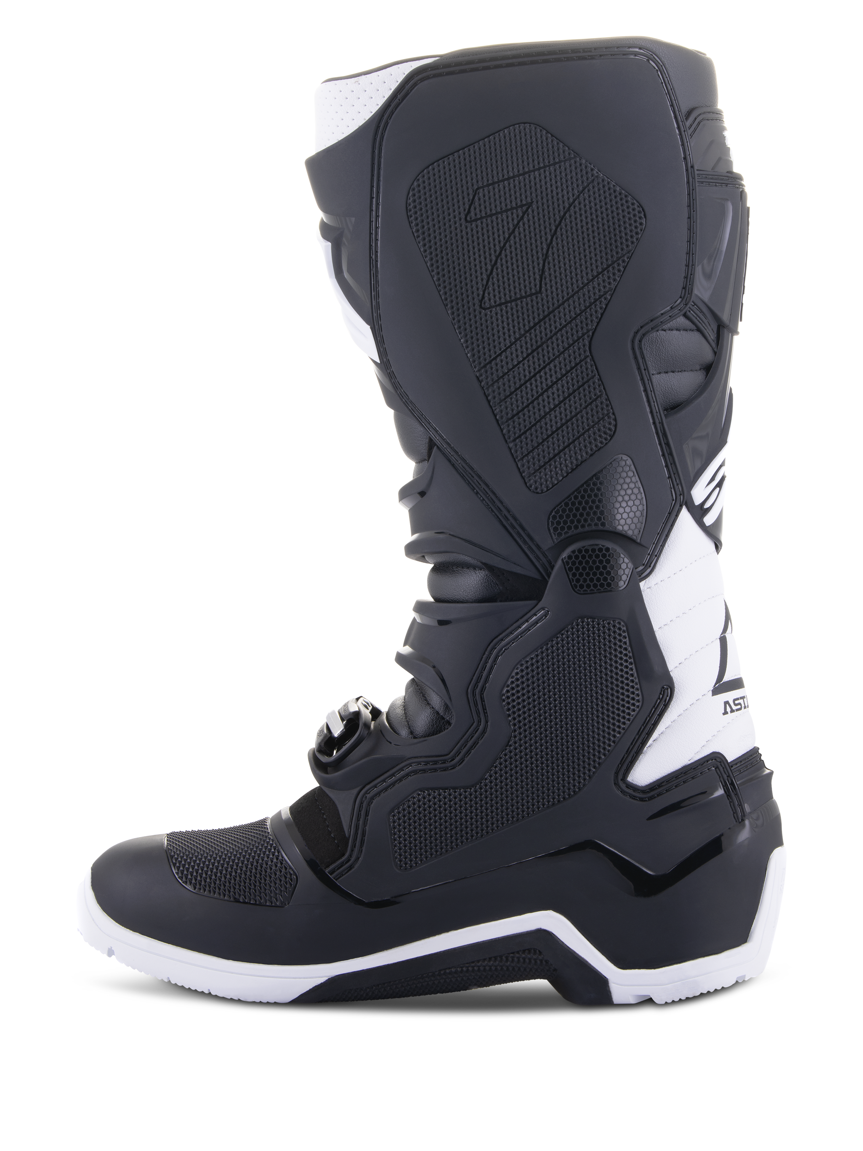 Alpinestars Tech 7 Enduro Drystar® Boots, Enduro Motorcycle Boots, Black and White, medial side view featuring honeycomb textured grip panels, TPU construction, and white accents on the heel and upper calf, professional off-road footwear