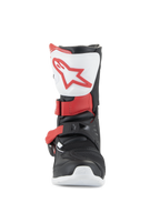 Botas Alpinestars Kids Tech 3S, botas de motocross, brancas, pretas e vermelho vivo, vista frontal mostrando placa de canela branca com logótipo vermelho, estrutura preta com correias de fivela vermelhas, calçado de proteção todo-o-terreno para jovens pilotos