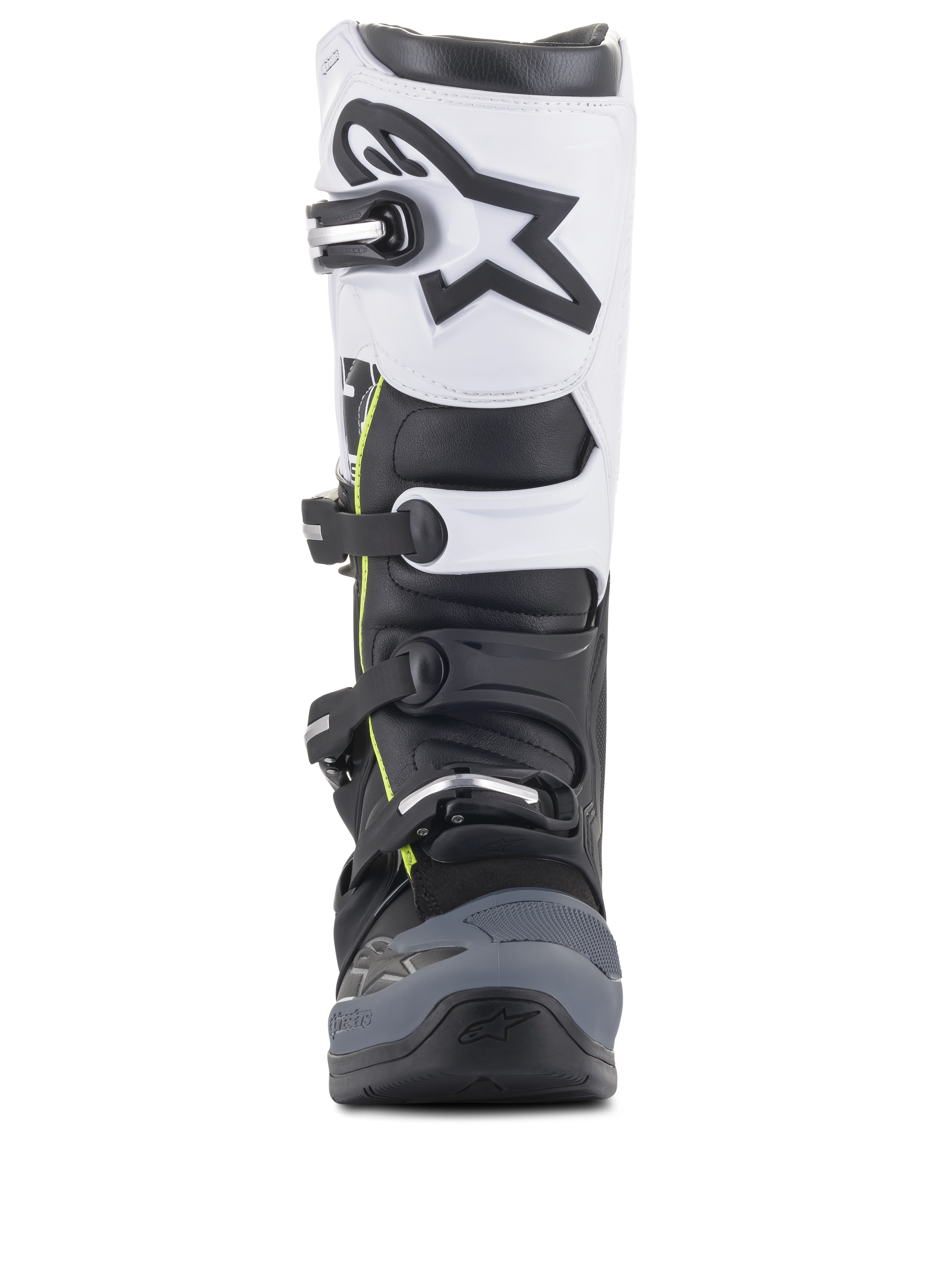 Botas Alpinestars Tech 5, botas de motocross, pretas, cinzento escuro e brancas, vista frontal com sistema de fecho de múltiplas fivelas, painel superior branco com logótipo Astars preto, biqueira reforçada em cinzento escuro e detalhes amarelos subtis