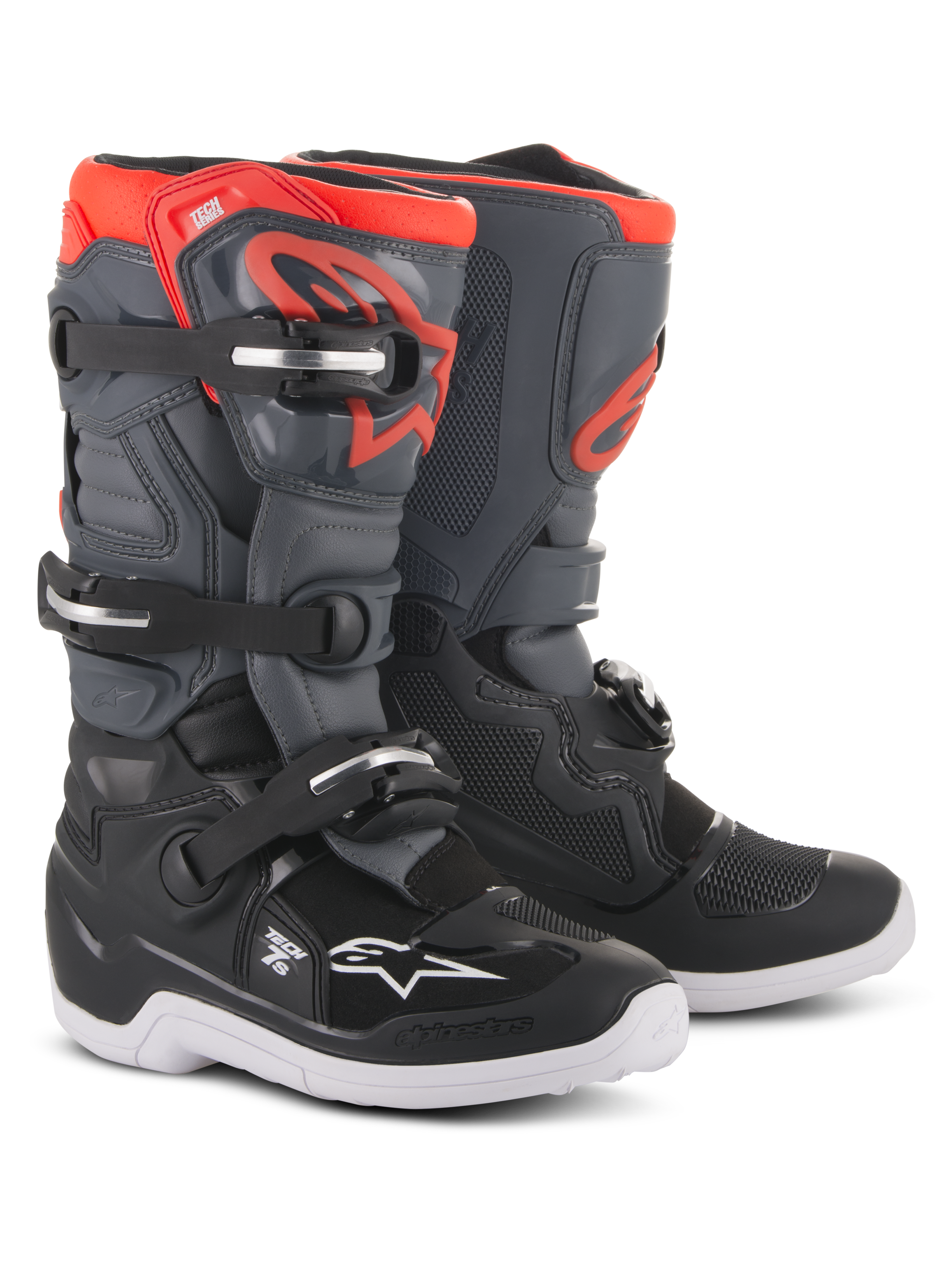 Botas Alpinestars Youth Tech 7S, botas de motocross, pretas, cinzento escuro e vermelho fluorescente, com sistema de fecho de quatro fivelas, placa de canela protetora em TPU, sola exterior branca e logótipo Alpinestars vermelho, concebidas para jovens pilotos de todo-o-terreno