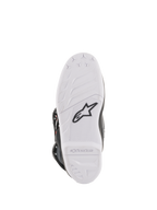 Botas Alpinestars Youth Tech 7S, botas de motocross, vista da sola inferior em branco, com logótipo da estrela Alpinestars em preto e marca em relevo, construção em composto durável com padrão de aderência de alto desempenho