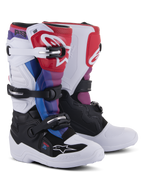 Botas Alpinestars Youth Tech 7S, botas de motocross, White Black Rainbow, com base branca e preta e detalhes em vermelho, azul e roxo, sistema de fecho com várias fivelas e placa protetora na canela para corridas todo-o-terreno