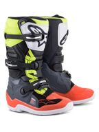 Alpinestars Youth Tech 7S Boots, Motocross Boots, Dark Gray with Red and Yellow Fluorescent accents, featuring a white TPU shin plate with black logo, triple buckle closure system, and durable white sole, designed for junior off-road riders.