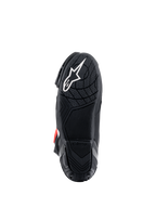 Botas Alpinestars Supertech R, vista da sola, composto de borracha leve preta com padrão de aderência texturizado, logótipo de estrela Alpinestars branco, calçado de performance para motociclismo de competição