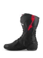Botas Alpinestars SMX-6 V3, botas de performance para motociclismo, pretas com detalhes em vermelho e prateado, vista de perfil lateral mostrando a construção em microfibra e os painéis de proteção em TPU, design derivado das corridas para desempenho em pista e estrada