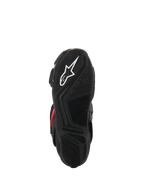 Botas Alpinestars SMX-6 V3 Drystar®, vista da sola, borracha preta texturizada para aderência, com um logótipo de estrela branco e marca Alpinestars em relevo, calçado de motociclismo de alta performance.