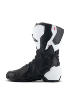 Botas Alpinestars Stella SMX-6 V3 Drystar®, botas de performance para motociclismo para mulher, brancas e pretas, vista lateral interna com marca Drystar em relevo, proteção de canela e calcanhar em TPU branco e parte superior em microfibra preta para performance em pista e estrada.