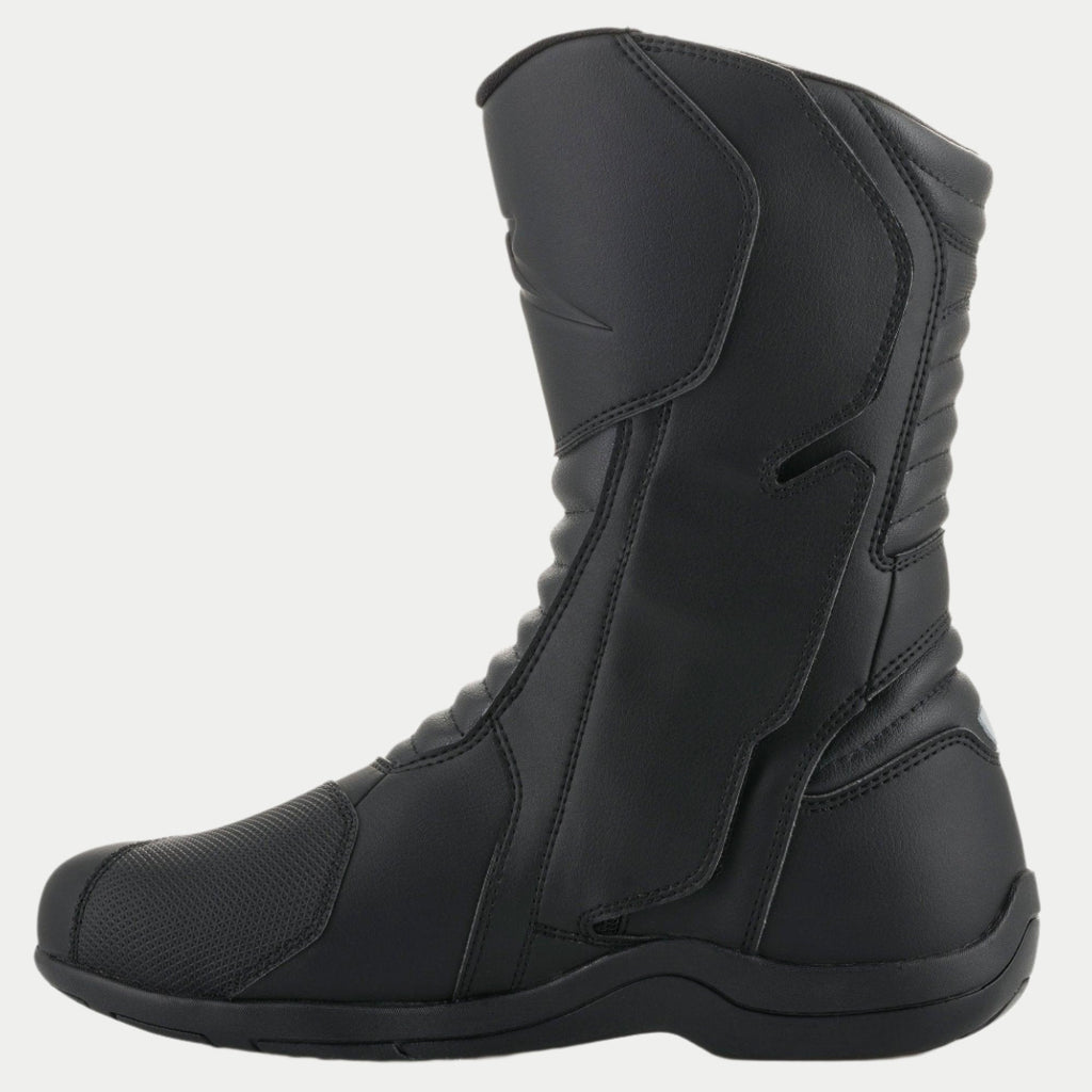 Alpinestars Origin Drystar® Boots, Black Motorcycle Touring Boots, side profile view of the medial side showing the entry system flap, microfiber upper with front and rear accordion flex zones, durable waterproof design for road and adventure riding