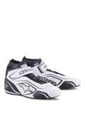 Alpinestars Tech-1 T V3 Shoes FIA, sapatos de corrida brancos e pretos, calçado profissional de automobilismo, certificação FIA, design de cano alto em pele com ventilação perfurada, tira de velcro no tornozelo e logótipo Astars preto em destaque.