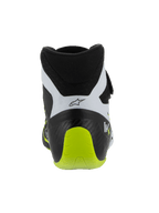 Sapatos Alpinestars Tech-1 KX V3, sapatos de karting com certificação FIA, preto, branco e amarelo néon, vista traseira mostrando o calcanhar reforçado de peça única, detalhe em amarelo néon vibrante, painéis brancos com logótipo preto, calçado técnico de automobilismo para uso em pista.