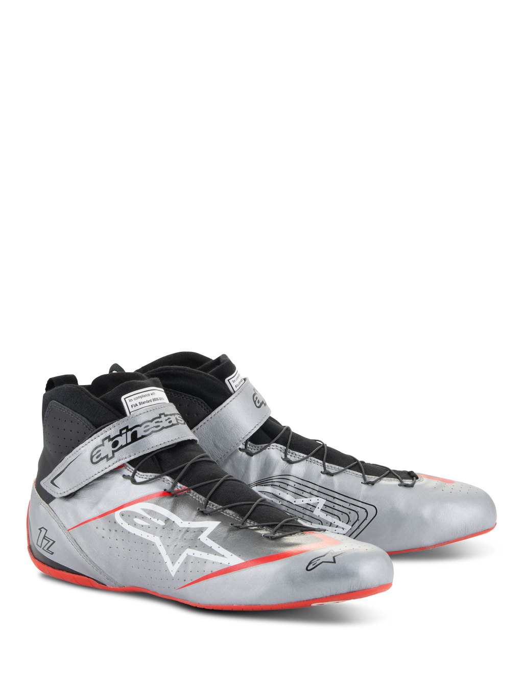 Sapatos Alpinestars Tech-1 Z V3 FIA, sapatos de automobilismo, prata escuro com detalhes em preto e vermelho, parte superior em couro prateado metálico com sistema de atacadores rápidos pretos, tira de tornozelo com marca e pormenores na sola fina vermelha.