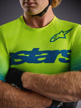 Camisola Alpinestars A-Dura ASTARS 2.0 em Amarelo Fluo, manga curta com grafismos azuis e tecido elástico de performance.
