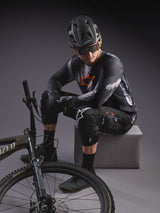 A-Dura Ride Shorts in Black Camo and long-sleeve jersey, styled with MTB gear and a Specialized mountain bike.